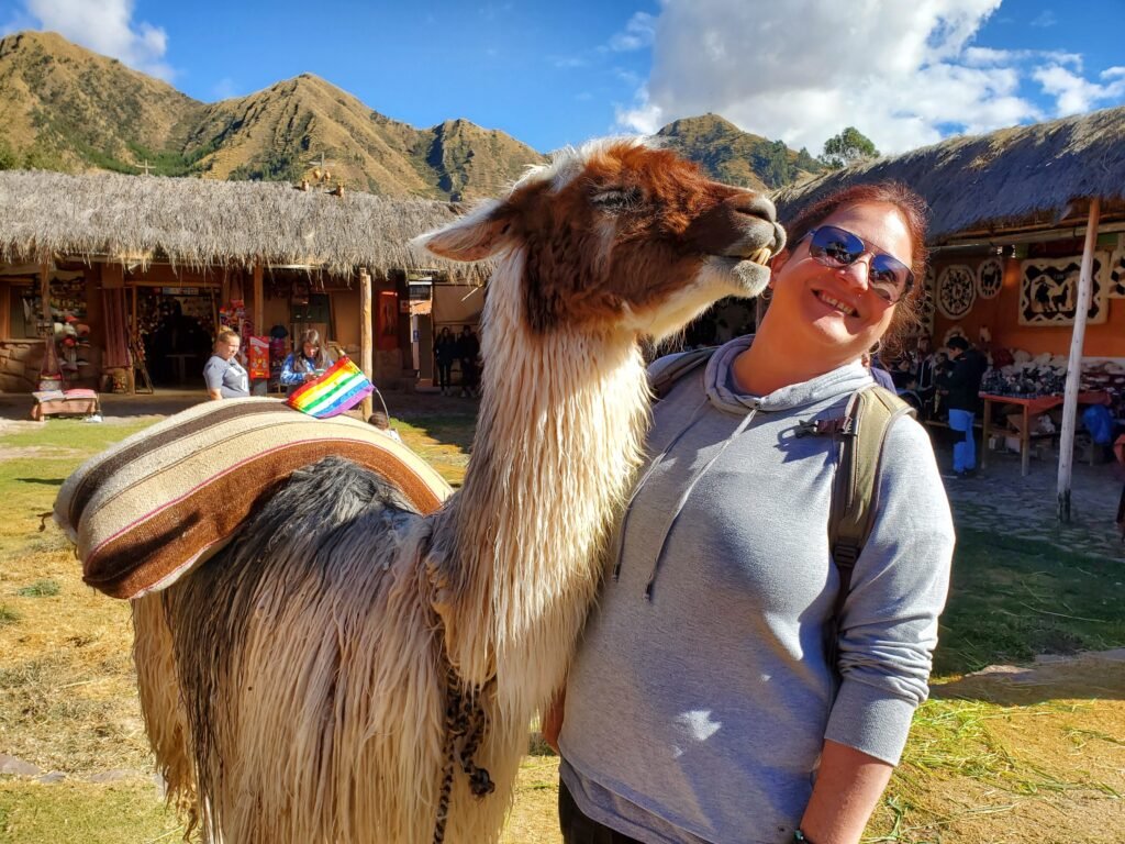 Vegan travel planner Angie having adventures in Peru with a llama