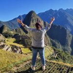 Meet Your Vegan Travel Expert & Experience Curator vegan travel planner having adventures at machu picchu
