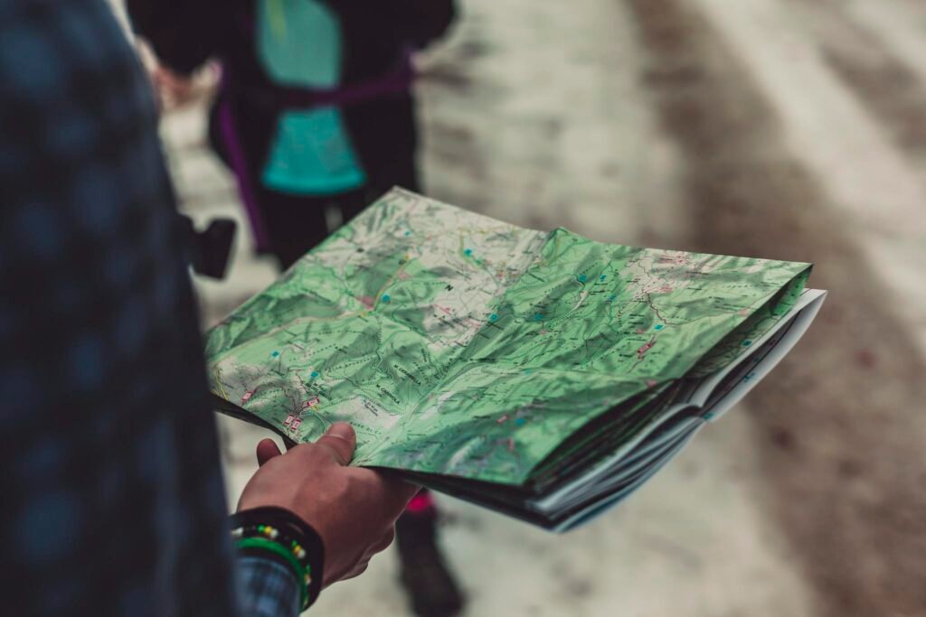 A close-up of a person holding a detailed route map outdoors, ideal for travel and exploration themes.