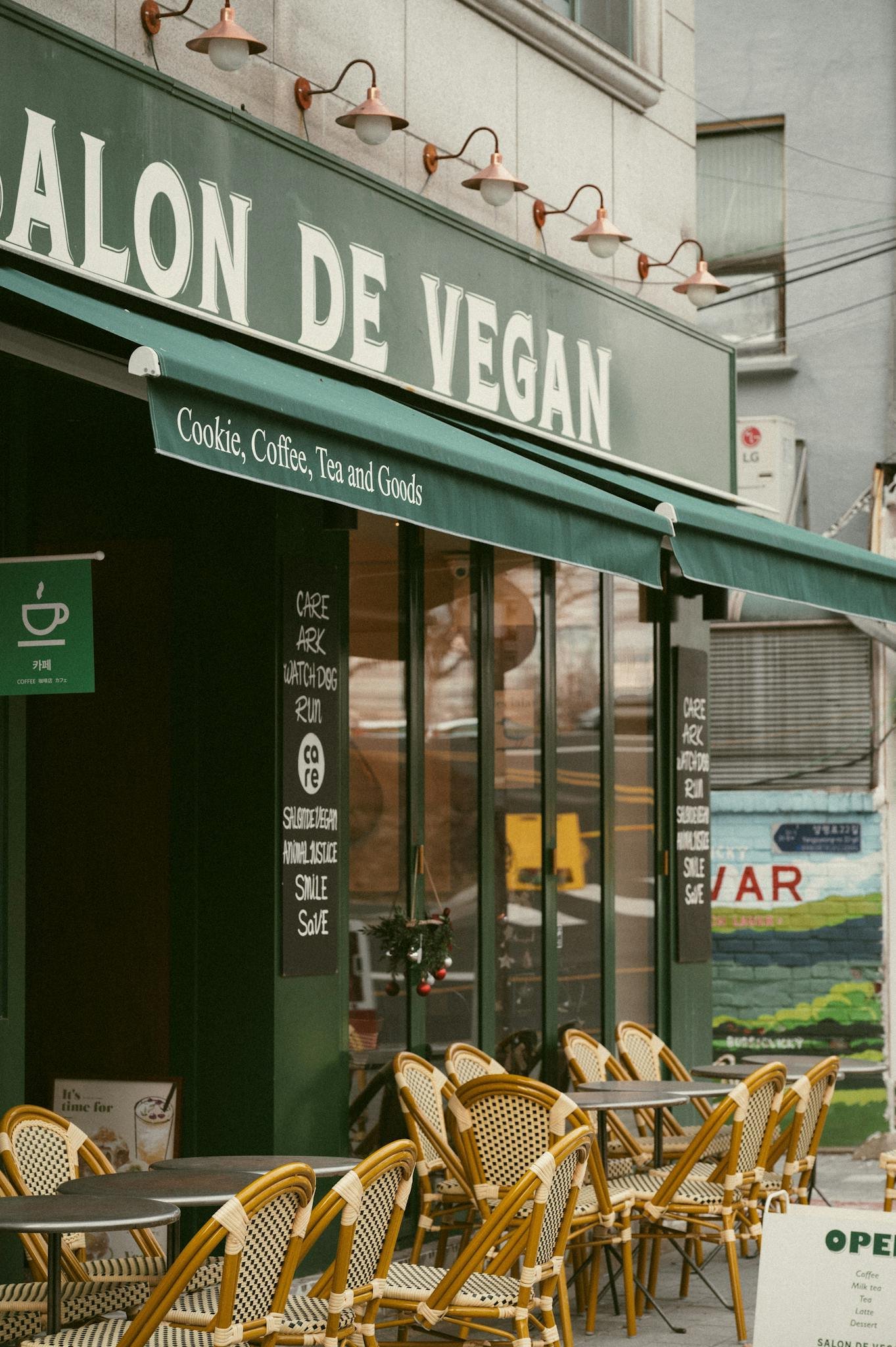 Street view of a charming vegan café with outdoor seating in a vegan friendly destinations.
