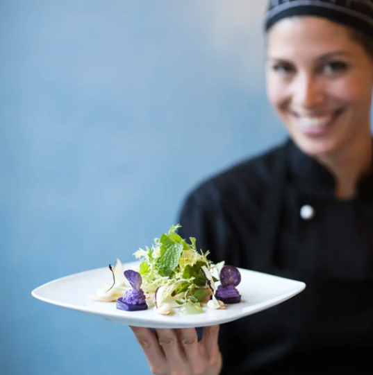 berlin vegan restaurant server holding plate of vegan food