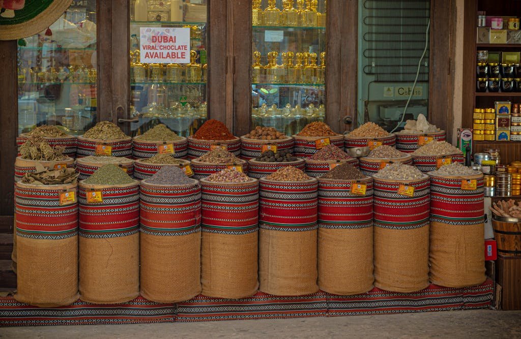 Colorful display of spices in Dubai's souk showcasing traditional Middle Eastern flavors and aromas. Fresh produce and vegetables at international market.