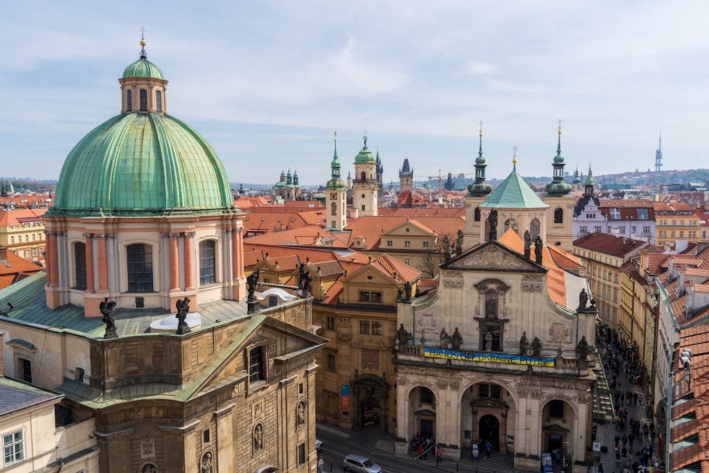 A breathtaking view of St. Francis of Assisi Church in Prague showcasing baroque architecture amidst cityscape.