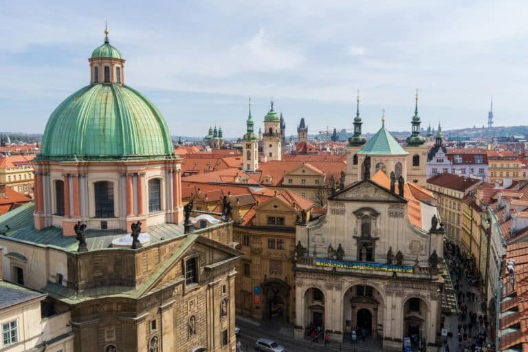 A breathtaking view of St. Francis of Assisi Church in Prague showcasing baroque architecture amidst cityscape.