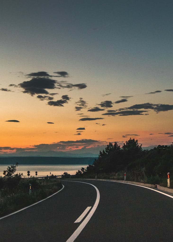 Beautiful curved road with sunset view and ocean in Korčula, Croatia.