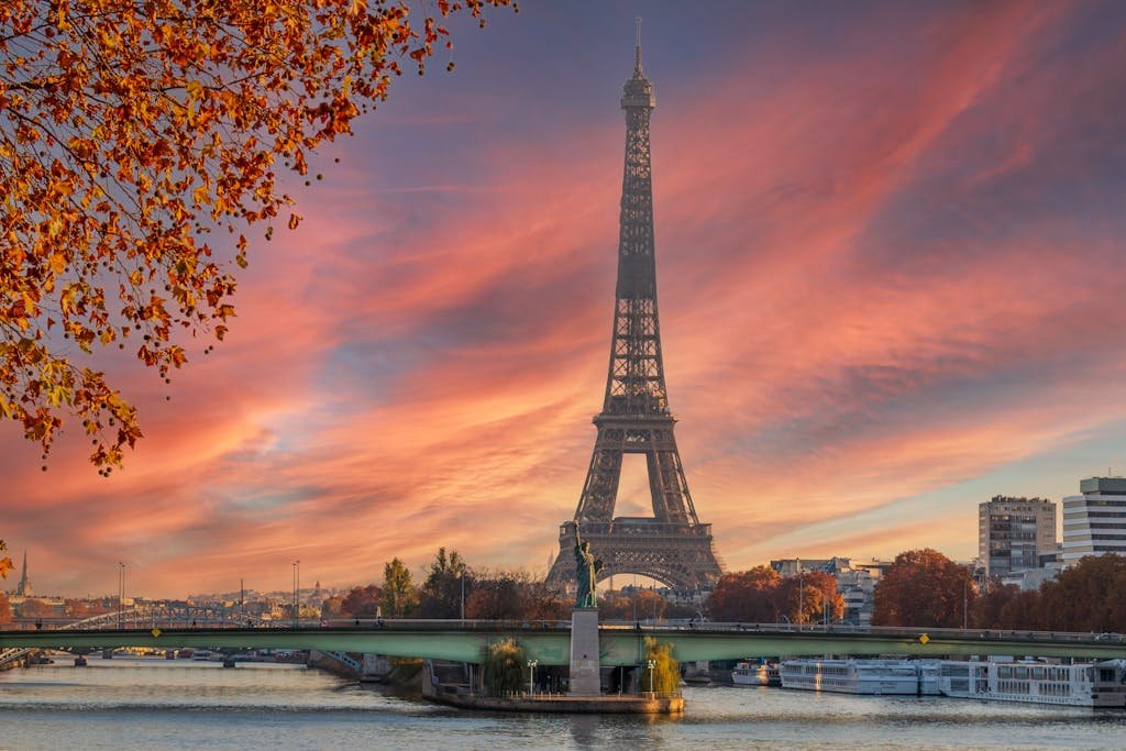 Stunning view of the Eiffel Tower during a colorful autumn sunset in Paris.