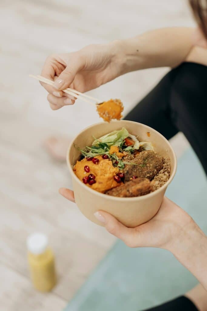 vegan traveler eating plant-based food at airport terminal before a flight