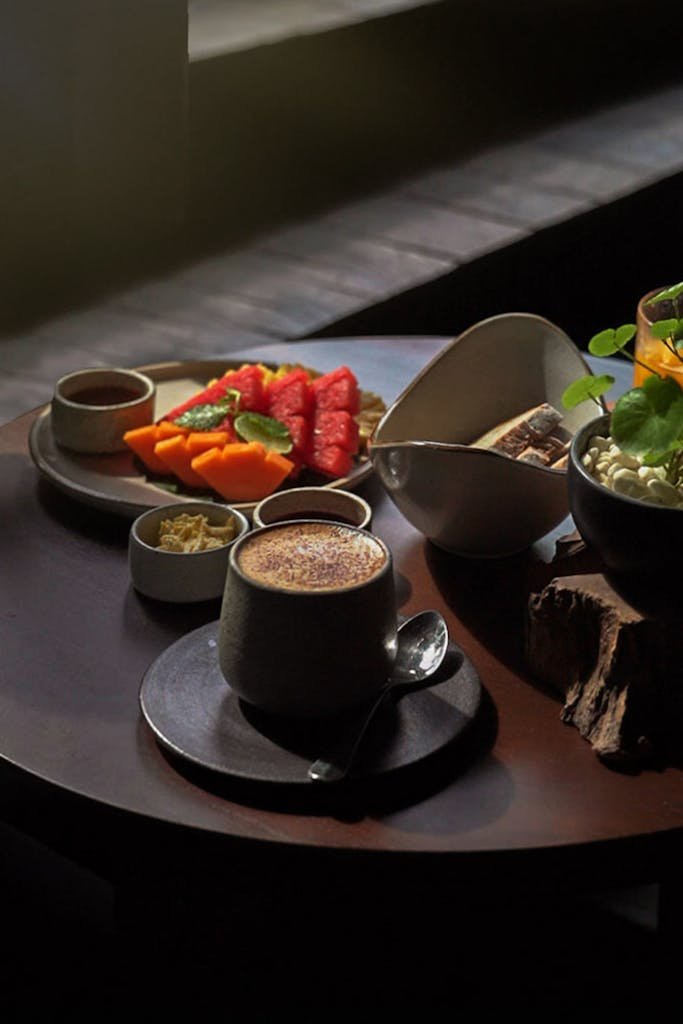 A cozy breakfast setup with tropical fruits and coffee in Bali, perfect for a serene morning.