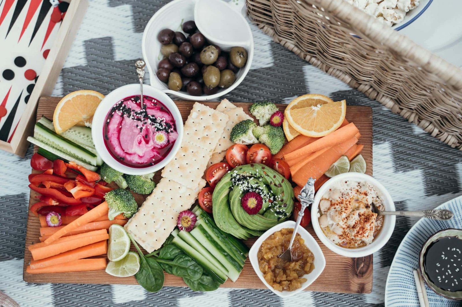 colorful vegan platter featuring fresh vegetables dips