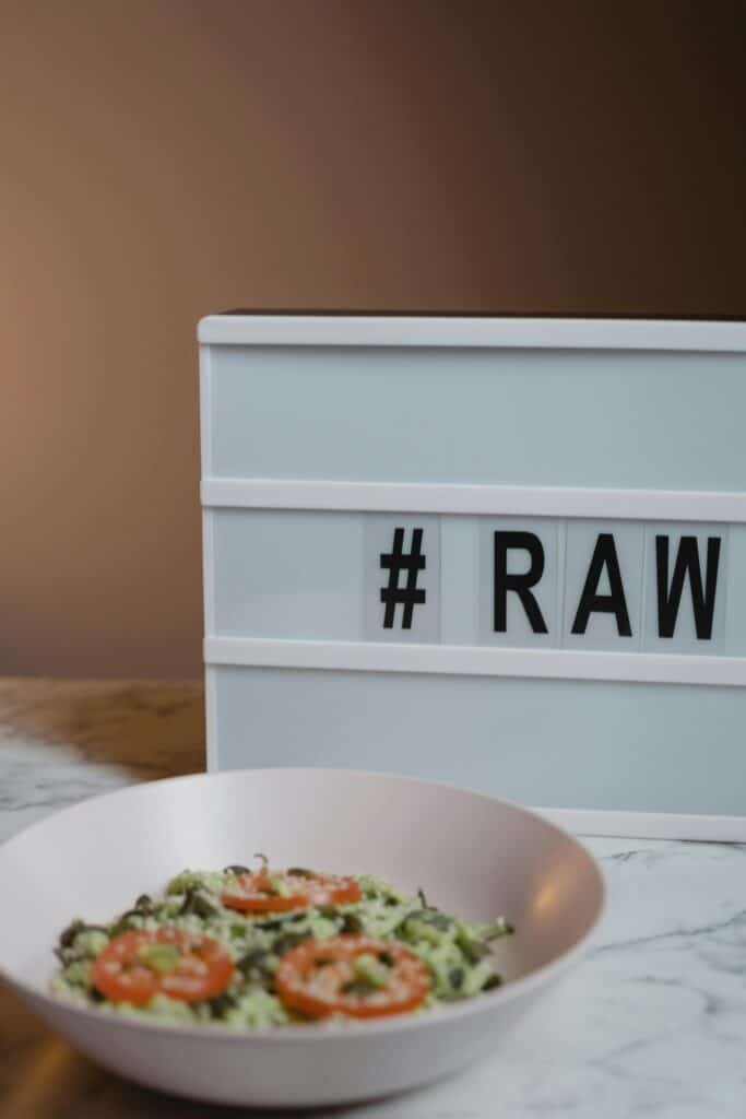 Discover a fresh vegan raw meal garnished with tomatoes, perfect for a healthy lifestyle.
