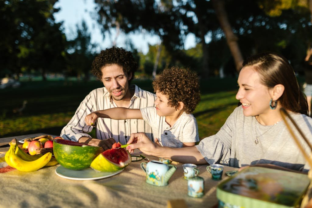 happy vegan family eating plant-based food at an outdoor restaurant abroad