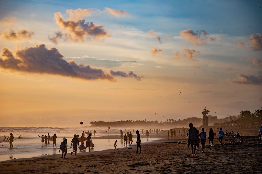 People enjoying a vibrant sunset at Canggu Beach, Bali, capturing leisure and tropical beauty.
