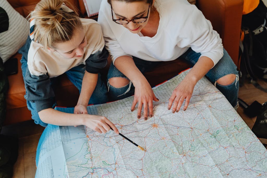 Vegan travel with kids. A mother and daughter plan their journey using a map, symbolizing adventure and bonding.