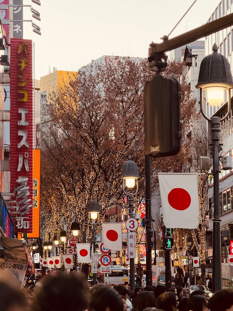 Dynamic evening scene in Shibuya, Tokyo, showcasing Japanese flags and city lights.