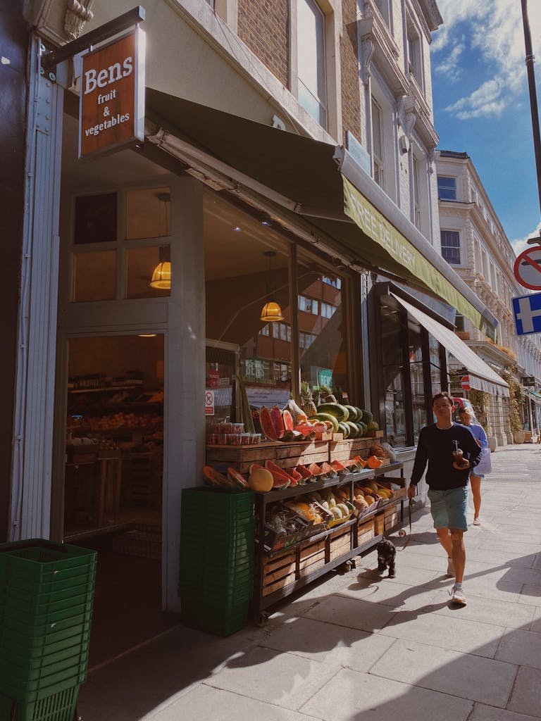 Street view of a fruit stand in Greater London, capturing urban life and vibrant produce display.
