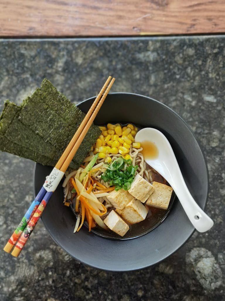 Vegan in Japan. Delicious Japanese-style vegan ramen bowl featuring tofu, seaweed, and vegetables.