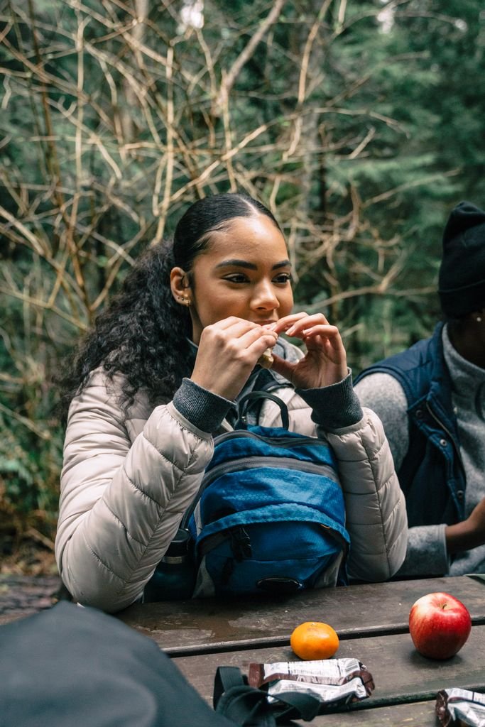packed snacks and water bottle for budget vegan travel
