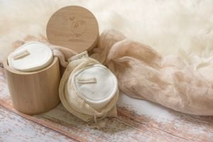 Sustainable reusable cotton pads in a bamboo container for eco-friendly skincare and makeup removal.