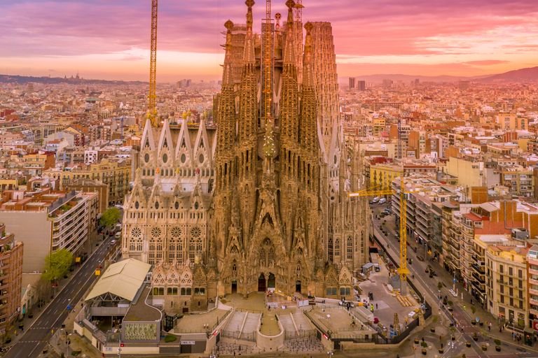 A breathtaking aerial capture of the Sagrada Familia in Barcelona during a vibrant sunset.