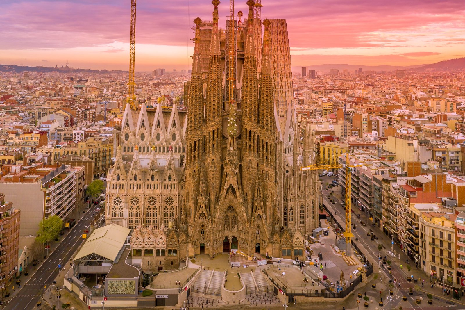 A breathtaking aerial capture of the Sagrada Familia in Barcelona during a vibrant sunset.