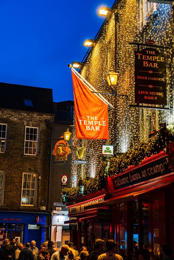 Bustling street scene at The Temple Bar in Dublin, Ireland, during a lively evening. vegan travel Ireland