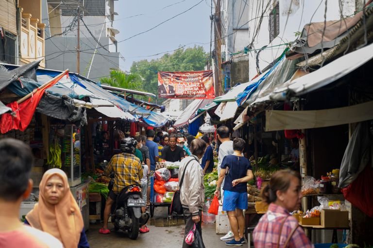 Busy outdoor market stalls in Southeast Asia. Local markets for vegan travelers.