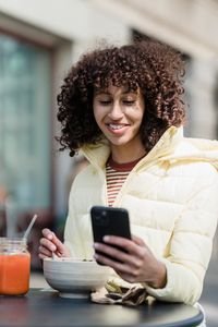 Checking a vegan restaurant finder app while traveling abroad