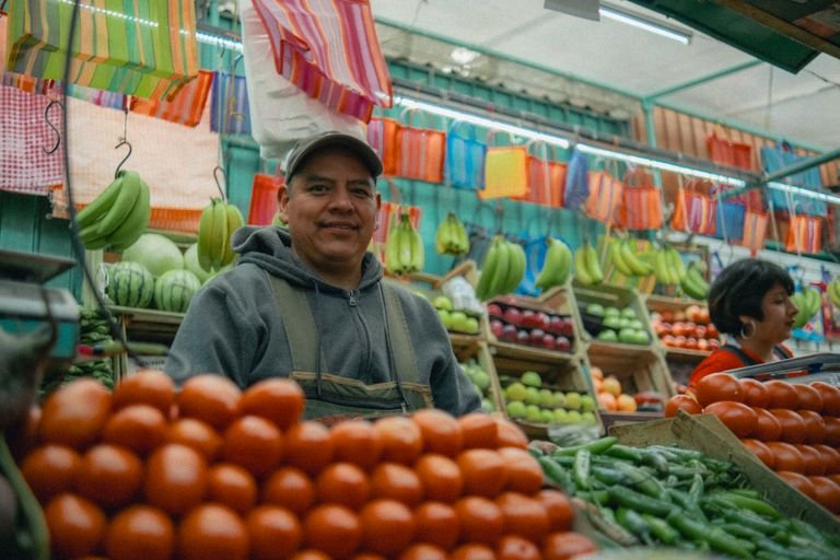 Colorful Mexican market with fresh fruits and vegetables and local vendors. Vegan Mexico City travel guide.