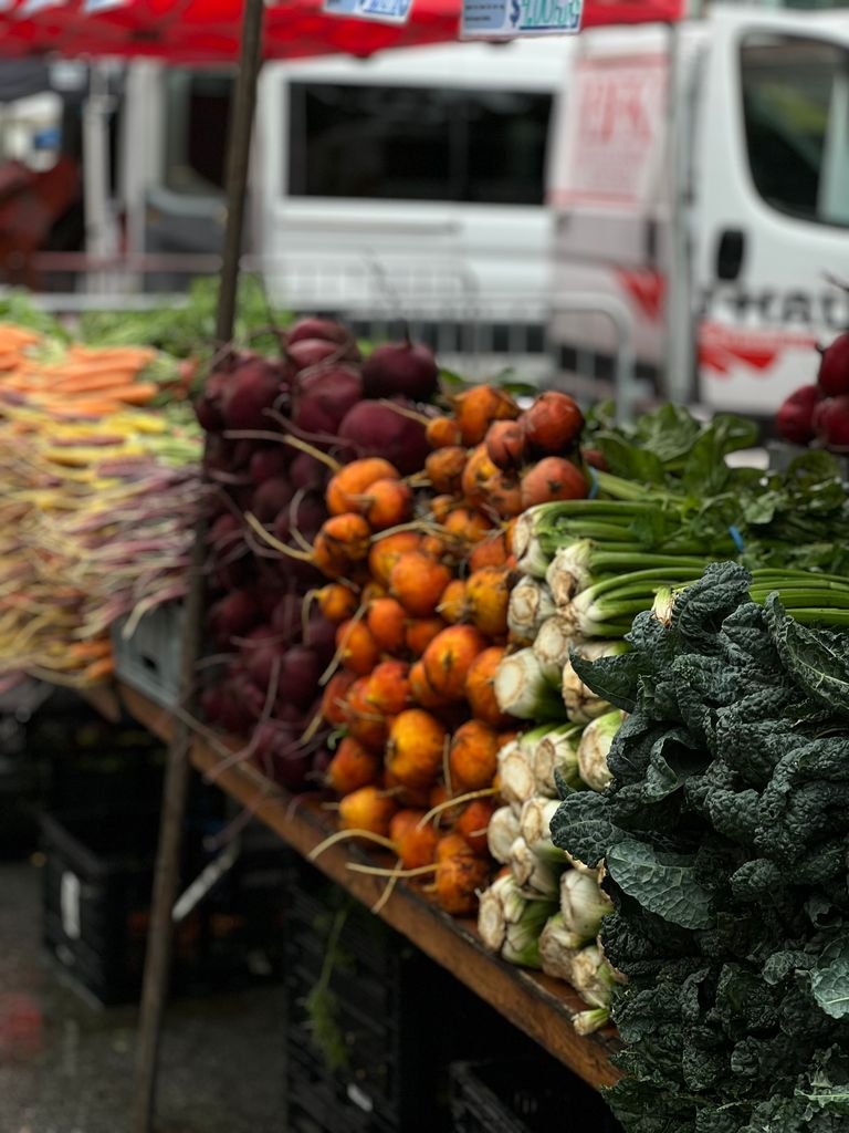 Colorful produce stall at a vegan-friendly local market
