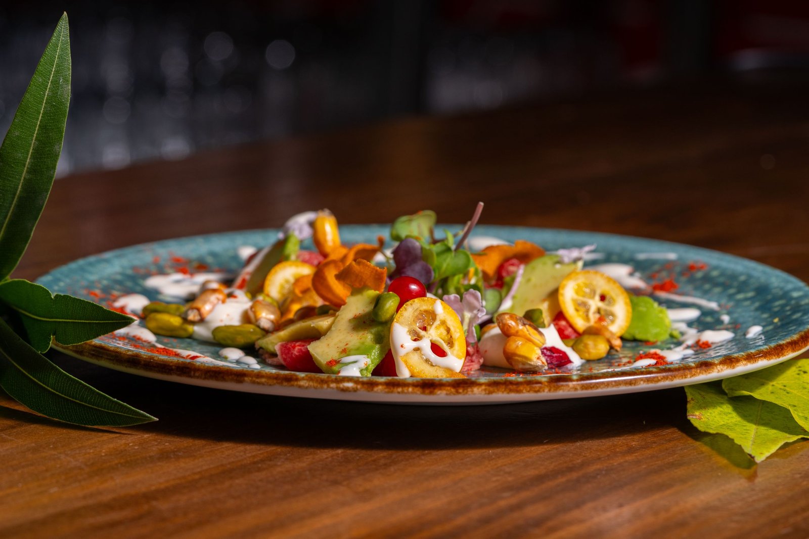 A vibrant gourmet salad with fresh ingredients artfully plated on a rustic dish.