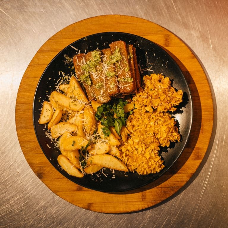 Delicious plant-based meal with roast potatoes, lentils, and tempeh, perfect for a savory dinner.