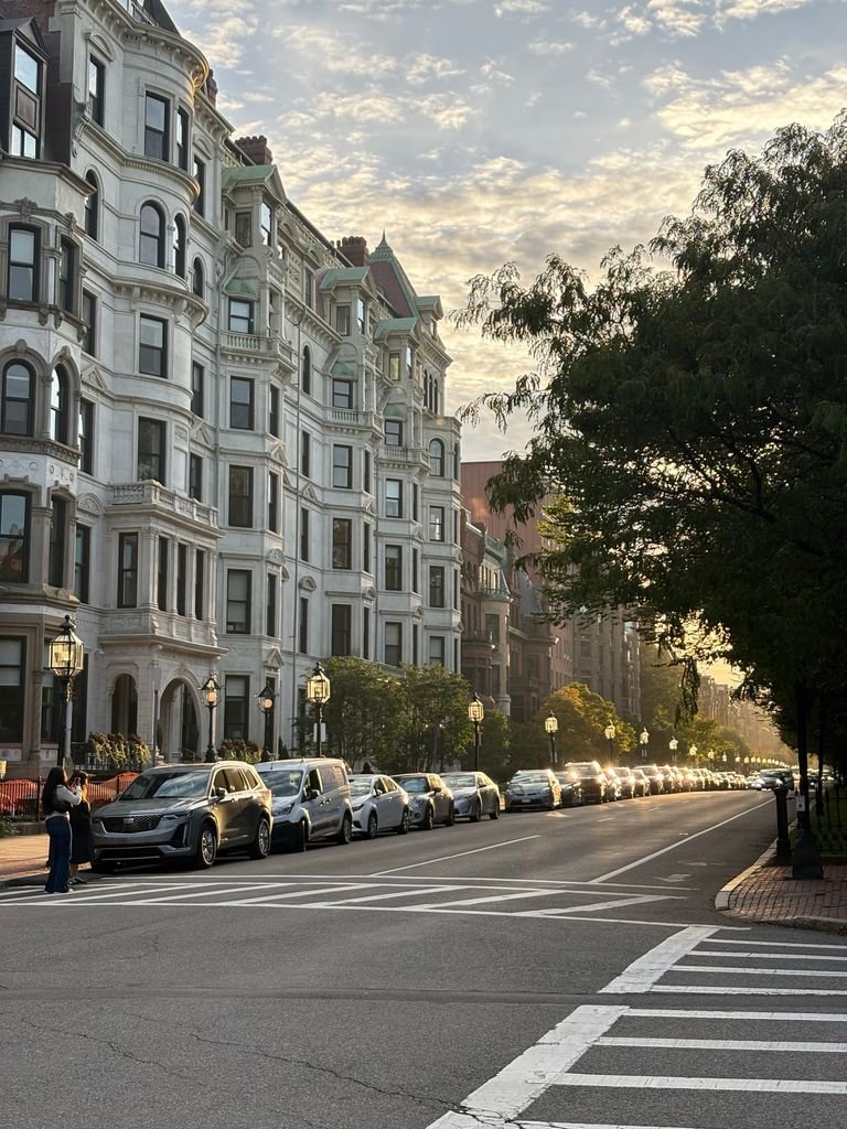 Elegant Boston street with historic architecture at sunset, showcasing urban charm and tranquility.