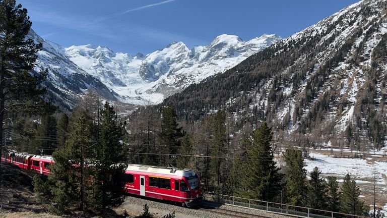 Glacier Express train traveling through the Swiss Alps