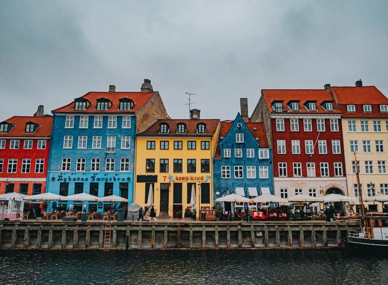 Vibrant Nyhavn harbor in Copenhagen showcasing colorful historic buildings by the water.