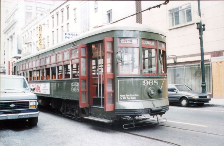 Vintage streetcar on St. Charles Avenue in New Orleans, showcasing urban charm.